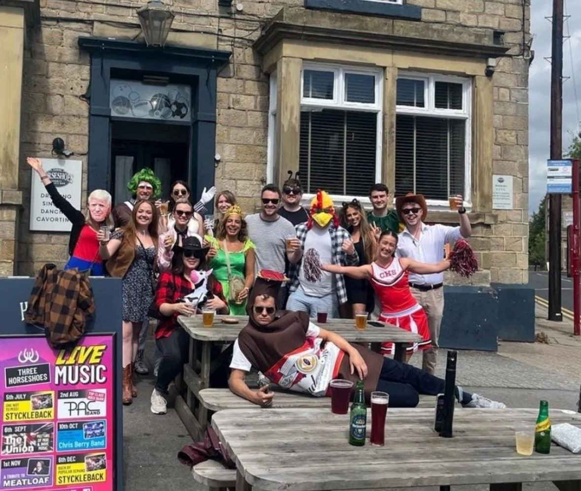 the whole team smiling together in fancy dress